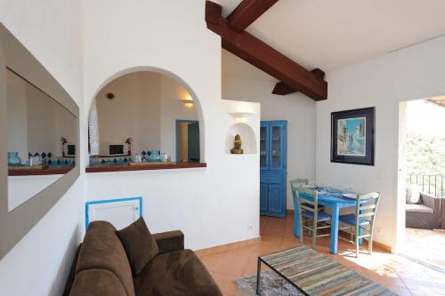 a living room with a couch and a table at Résidence Belvedere de Palombaggia in Porto-Vecchio