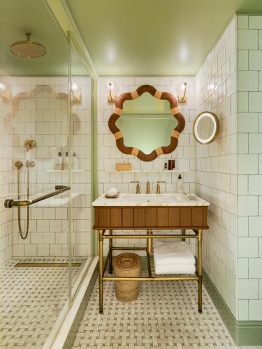 a bathroom with a sink and a shower at La Fantaisie in Paris