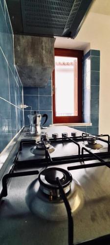 a stove top in a kitchen with a window at Casa Costa in Lipari