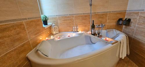 a bath tub in a bathroom with lights on it at Apartment Beauty Tatry with a view of the mountains in Nová Lesná