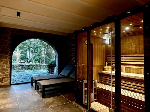 a sauna with a bench in the middle of a room at Châteaux de Méliris in Tenneville