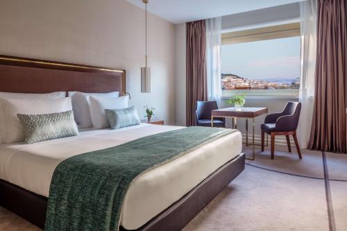 a hotel room with a large bed and a window at Tivoli Avenida Liberdade Lisboa – A Leading Hotel of the World in Lisbon