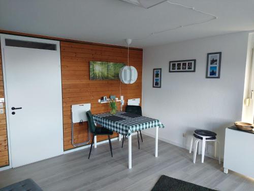a dining room table with a black and white checkered table cloth at Schwarzwald Pur in Sasbachwalden