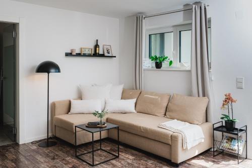 a living room with a couch and a window at Wachaulodge in Weissenkirchen in der Wachau