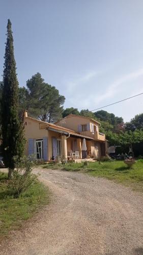 a house with a gravel road in front of it at Les Cigales in Villelaure