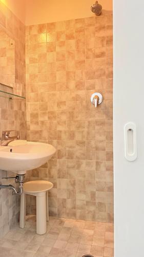 a bathroom with a sink and a toilet at Hotel Ardesia in Rimini
