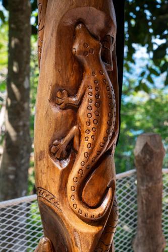 a wooden carving of a snake on a post at Makako Lodge in Ampangorinana