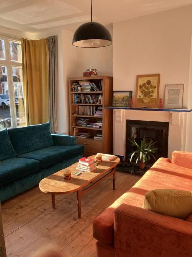 a living room with a couch and a coffee table at Ensuite Victorian double, excellent transport links to Bham in Birmingham