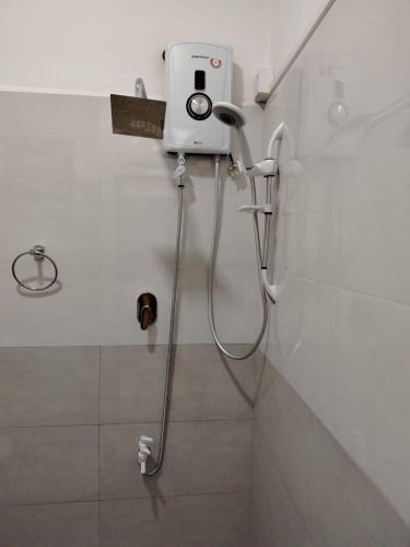 a shower in a bathroom with a camera on the wall at Diora Hotel in Ratnapura