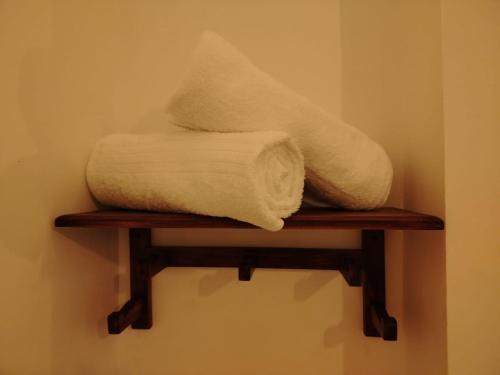 two towels sitting on a shelf in a room at Diora Hotel in Ratnapura