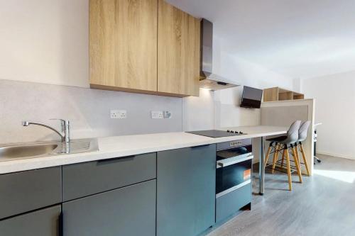 a kitchen with a sink and a counter top at Canvas Glasgow in Glasgow