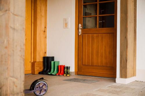 a group of boots sitting in front of a door at Holzhof in Breitnau