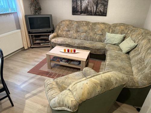 a living room with a couch and a coffee table at Ruheoase Ahlbeck bei Ueckermünde in Ahlbeck