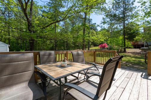 a wooden table and chairs on a deck at Serenity Haven in Lillington