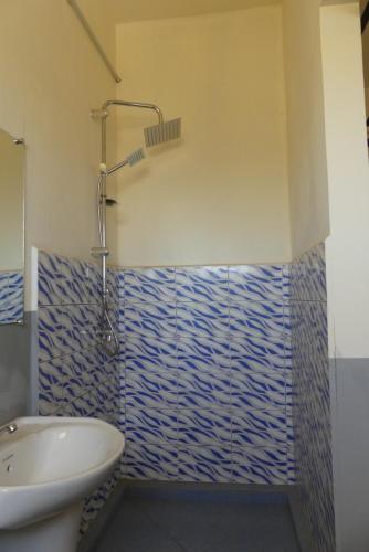a bathroom with a sink and a toilet and a shower at Centre Lucien Botovasoa in Diego Suarez