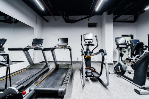 a gym with several treadmills and cardio machines at Vuelo Sobre by In Property in Becici