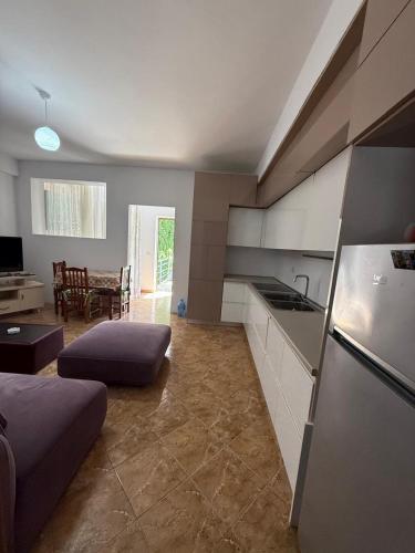 a room with a kitchen and a living room at Heart of Vlore Walk to Beach in Vlorë