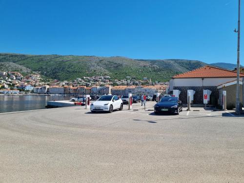 two cars parked in a parking lot next to a body of water at Bruno 1 in Senj