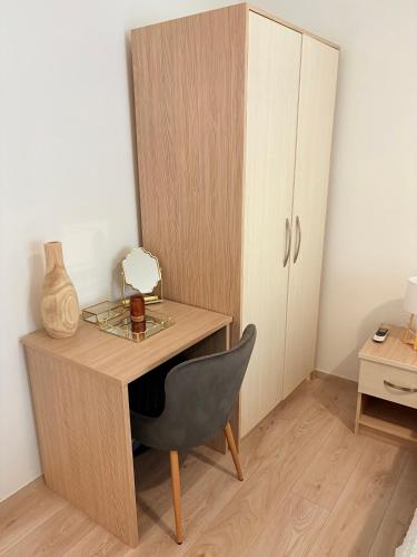 a wooden desk with a chair next to a cabinet at Apartment Anđelina, Split in Split