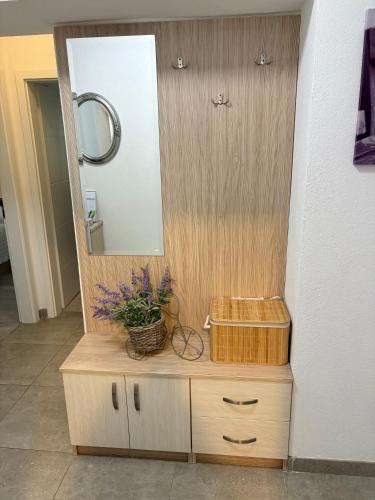a bathroom with a vanity with a mirror and a basket at Apartment Anđelina, Split in Split