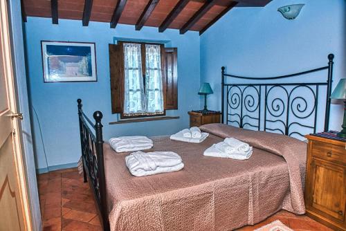 Ένα ή περισσότερα κρεβάτια σε δωμάτιο στο Niccoli's Holiday Home In Tuscany