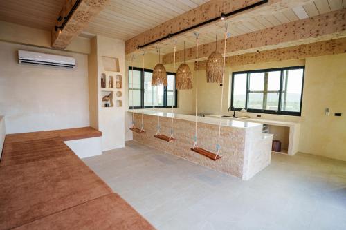 a large room with a counter and some windows at 墾丁包棟民宿-宇樂 in Hengchun