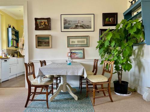 a dining room with a table and chairs at The West Wing - Bride Valley - Jurassic Coast in Long Bredy