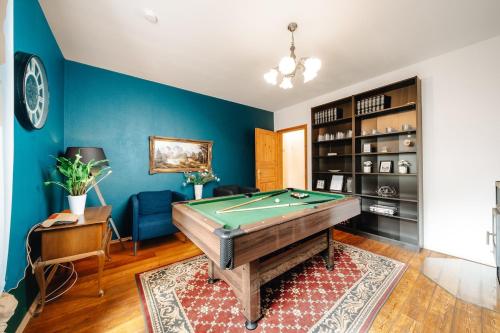 a living room with a pool table and blue walls at WagnerStays BadEms Historic VillaWhirpool Billiard in Bad Ems