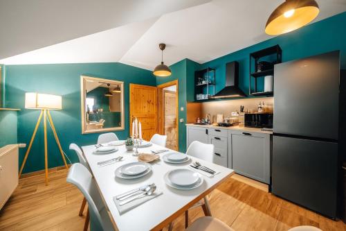 a kitchen and dining room with a white table and chairs at WagnerStays BadEms Historic VillaWhirpool Billiard in Bad Ems