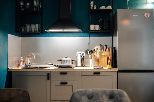 a small kitchen with a sink and a refrigerator at WagnerStays BadEms Historic VillaWhirpool Billiard in Bad Ems