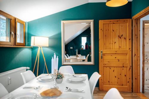 a dining room with a table and a mirror at WagnerStays BadEms Historic VillaWhirpool Billiard in Bad Ems