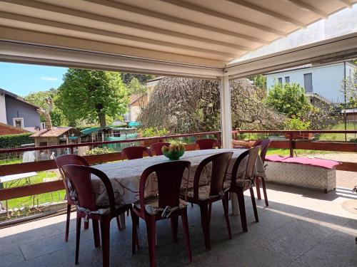 a dining table and chairs on a patio at La Cinciallegra in Val Della Torre