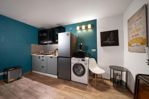 a kitchen with a refrigerator and a washing machine at WagnerStays BadEms Historic VillaWhirpool Billiard in Bad Ems
