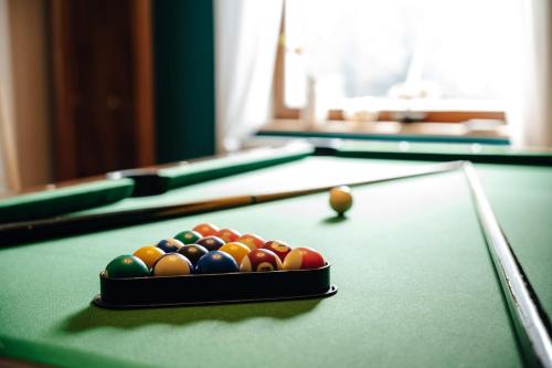 a container of billiard balls on a pool table at WagnerStays BadEms Historic VillaWhirpool Billiard in Bad Ems