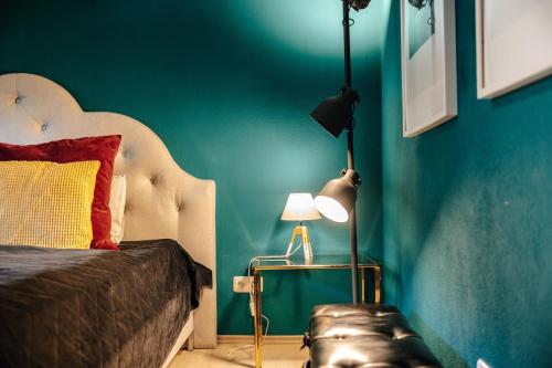 a bedroom with a bed and a green wall at WagnerStays BadEms Historic VillaWhirpool Billiard in Bad Ems