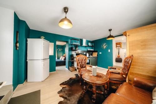 a living room with a table and a refrigerator at WagnerStays BadEms Historic VillaWhirpool Billiard in Bad Ems