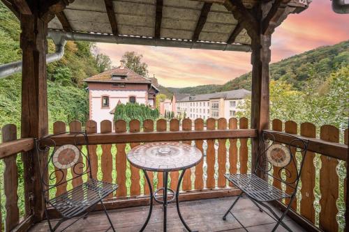 a table and chairs on a balcony with a house at WagnerStays BadEms Historic VillaWhirpool Billiard in Bad Ems