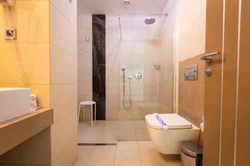 a bathroom with a shower and a toilet and a sink at Apollonia Hotel Gevgelija in Gevgelija