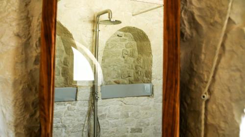 a shower in a bathroom with a mirror at Masseria Surace in Noci