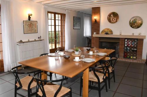 a dining room with a wooden table and chairs at Grande maison proche du Zoo de Beauval pour 16 personnes ! in La Ferté-Saint-Cyr