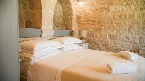 a bedroom with a bed with two towels on it at Masseria Surace in Noci