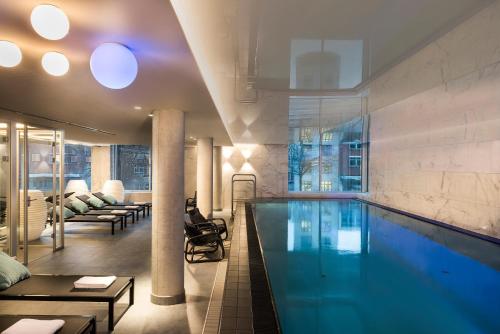 a large swimming pool in a hotel room at Adina Apartment Hotel Hamburg Speicherstadt in Hamburg