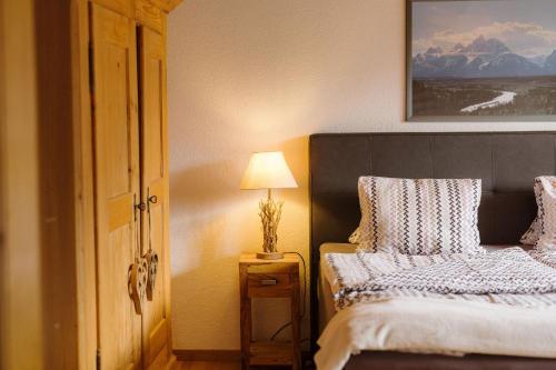 a bedroom with two beds and a lamp on a table at Alba in Frutigen
