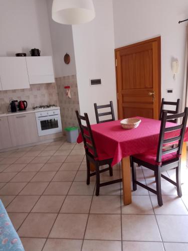 a dining room with a table with a pink table cloth at Il Pesco - CIR 0024 in Nus