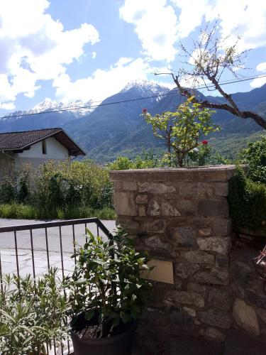 a stone wall with a view of a mountain at Il Pesco - CIR 0024 in Nus