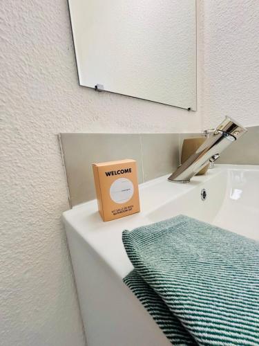 un lavabo de salle de bain avec une boîte posée dessus dans l'établissement 5 min de la Mer à pieds,Plage Richelieu,Le Cap d Agde,pour 2ou 4pers, au Cap d'Agde