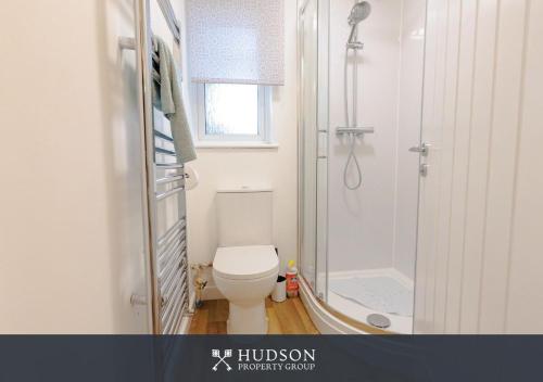 a bathroom with a toilet and a shower at 1-Bedroom Apartment with Parking in Wellington