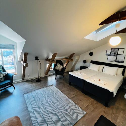 a bedroom with a bed and a couch and a chair at Stekhuset B&B in Kalmar