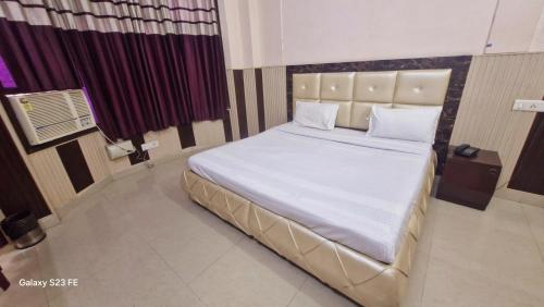 Ένα ή περισσότερα κρεβάτια σε δωμάτιο στο Hotel Asia Palace