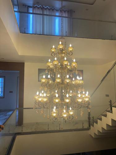 a chandelier hanging from the ceiling in a building at The Bunglo (Villa) in Allahābād
